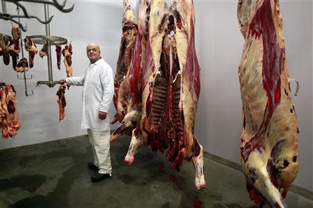 Lawrie Malcolmson, 48, poses for a photograph at his work in an abattoir near the town of Lerwick on the Shetland Islands April 2, 2014. REUTERS/Cathal McNaughton