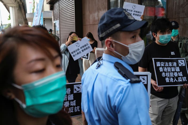 Activists march against new security laws, near China's Liaison Office, in Hong Kong