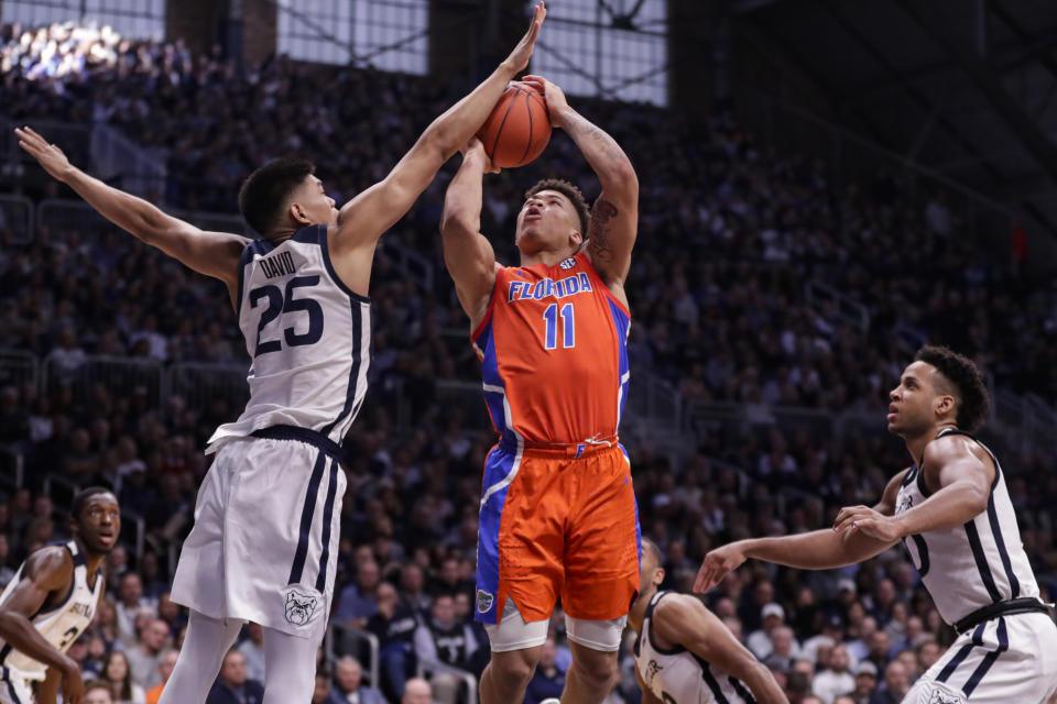 Butler forward Christian David (25) blocks the shot of Florida forward Keyontae Johnson (11) in the second half of an NCAA college basketball game in Indianapolis, Saturday, Dec. 7, 2019. Butler defeated Florida 76-62. (AP Photo/Michael Conroy)