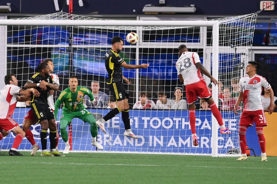 Defender Rudy Camacho heads the ball in against New England to score his first-ever goal with the Crew.