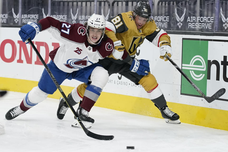 Colorado Avalanche defenseman Ryan Graves (27) vies for the puck with Vegas Golden Knights center Jonathan Marchessault (81) during the second period of an NHL hockey game Wednesday, April 28, 2021, in Las Vegas. (AP Photo/John Locher)