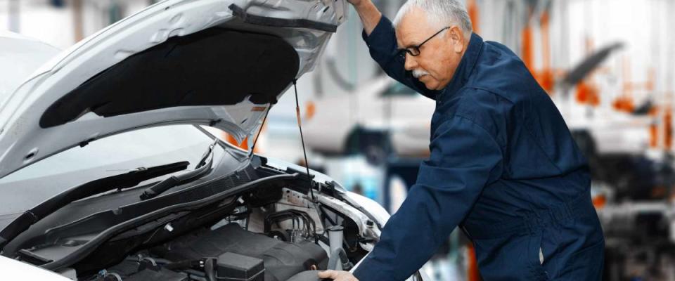 Car mechanic in uniform. Auto repair service.