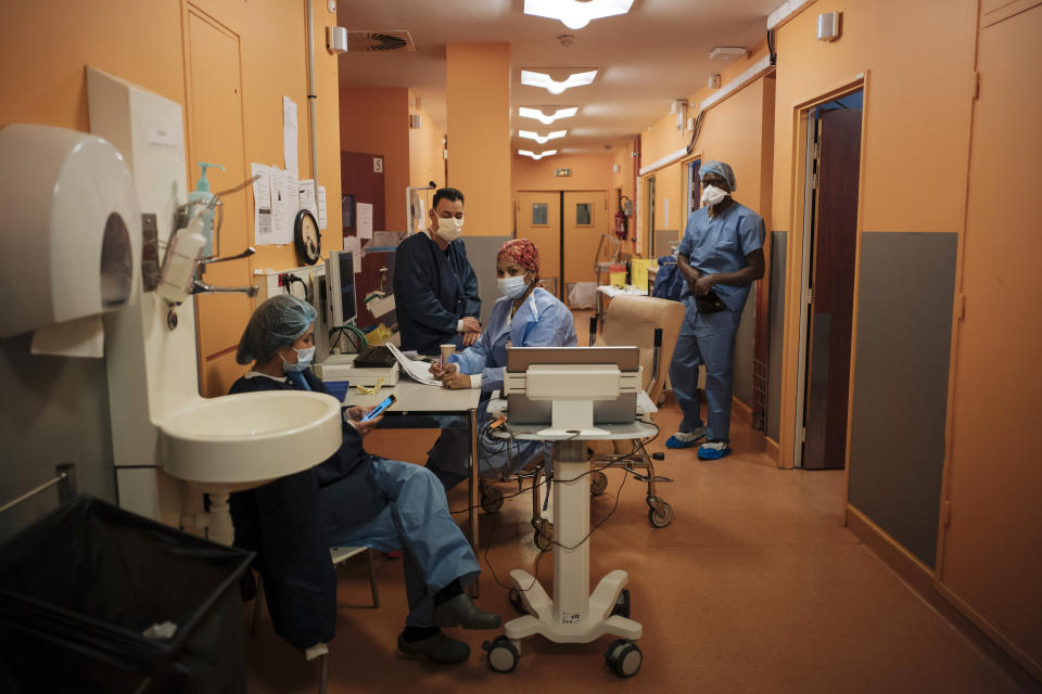 Student nurse Soraya Ngin Tun, left, Dr. Atanas Sabahov, center left, nurse Rim Omrani, center right, and student nurse Landry Nzoyem, right, rest at Bichat Hospital, AP-HP, in Paris, Thursday, April 22, 2021. France still had nearly 6,000 critically ill patients in ICUs this week as the government embarked on the perilous process of gingerly easing the country out of its latest lockdown, too prematurely for those on pandemic frontlines in hospitals. President Emmanuel Macron's decision to reopen elementary schools on Monday and allow people to move about more freely again in May, even though ICU numbers have remained stubbornly higher than at any point since the pandemic's catastrophic first wave, marks another shift in multiple European capitals away from prioritizing hospitals. (AP Photo/Lewis Joly)