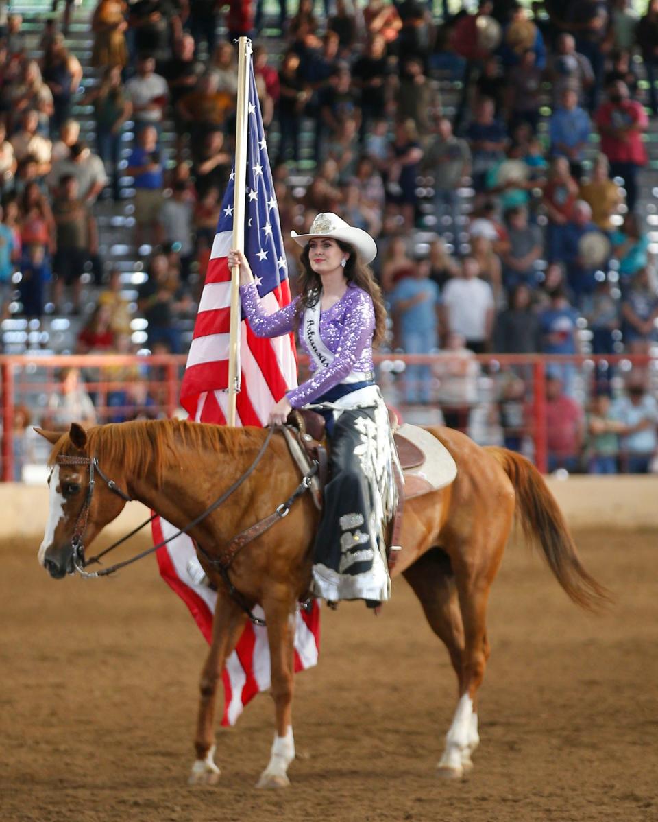 Miss Arkansas Rodeo Molly Musick presents the colors before the start of the national anthem at the 89th Annual Old Fort Days Rodeo on June 1, 2022, at Kay Rodgers Park in Fort Smith.