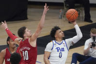 Pittsburgh's Ithiel Horton (0) shoots as Louisville's Samuell Williamson (10) defends during the second half of an NCAA college basketball game Tuesday, Dec. 22, 2020, in Pittsburgh. (AP Photo/Keith Srakocic)