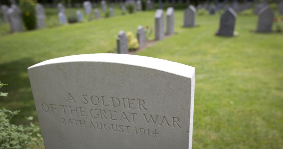 FILE - In this In this Saturday, July 26, 2014 file photo the grave of an unknown Commonwealth World War I soldier, foreground, and German soldiers graves, background, at the St. Symphorien Cemetery near Mons, Belgium. The Commonwealth War Graves Commission has apologized after an investigation found that at least 161,000 mostly African and Indian men who died fighting for the British Empire during World War I weren’t properly honored due to “pervasive racism.” The investigation found that at least 116,000 people, and possibly as many as 350,000, were either not commemorated by name or weren’t commemorated at all, according to findings released Thursday, April 22, 2021. (AP Photo/Virginia Mayo, File)