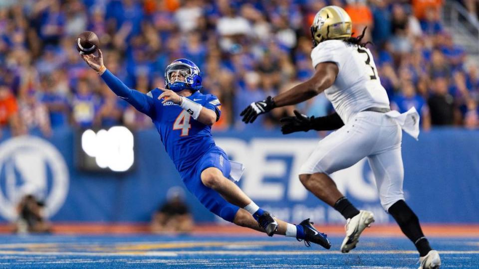 Boise State quarterback Maddux Madsen passes the football while falling away from UCF defensive end Tre’Mon Morris-Brash in the 4th quarter, Saturday, Sept. 9, 2023.