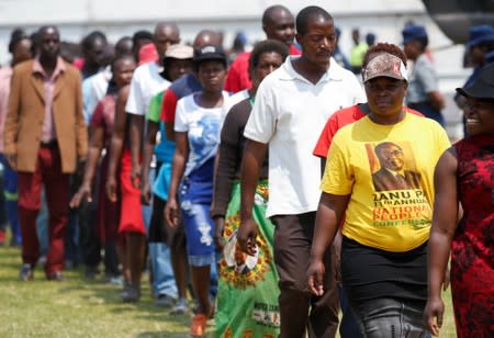 Mourners queue to pay their last respects to Former Zimbabwean president Robert Mugabe as he lies in state at the at Rufaro stadium