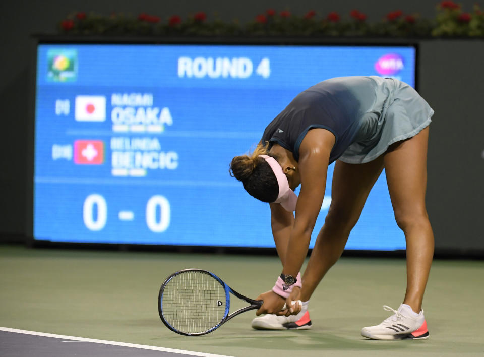 Naomi Osaka, of Japan, reacts after losing a point to Belinda Bencic, of Switzerland, at the BNP Paribas Open tennis tournament Tuesday, March 12, 2019 in Indian Wells, Calif. (AP Photo/Mark J. Terrill)