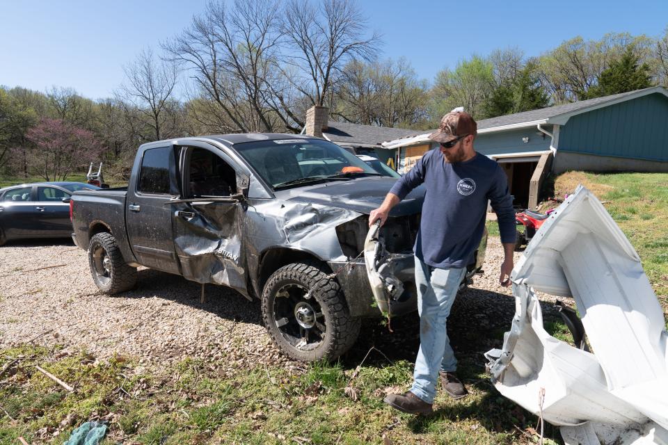 Overbrook resident Ethan Steenback recovers parts of his truck that were ripped off after an EF-1 tornado came through his property early Tuesday morning in southern Shawnee County.