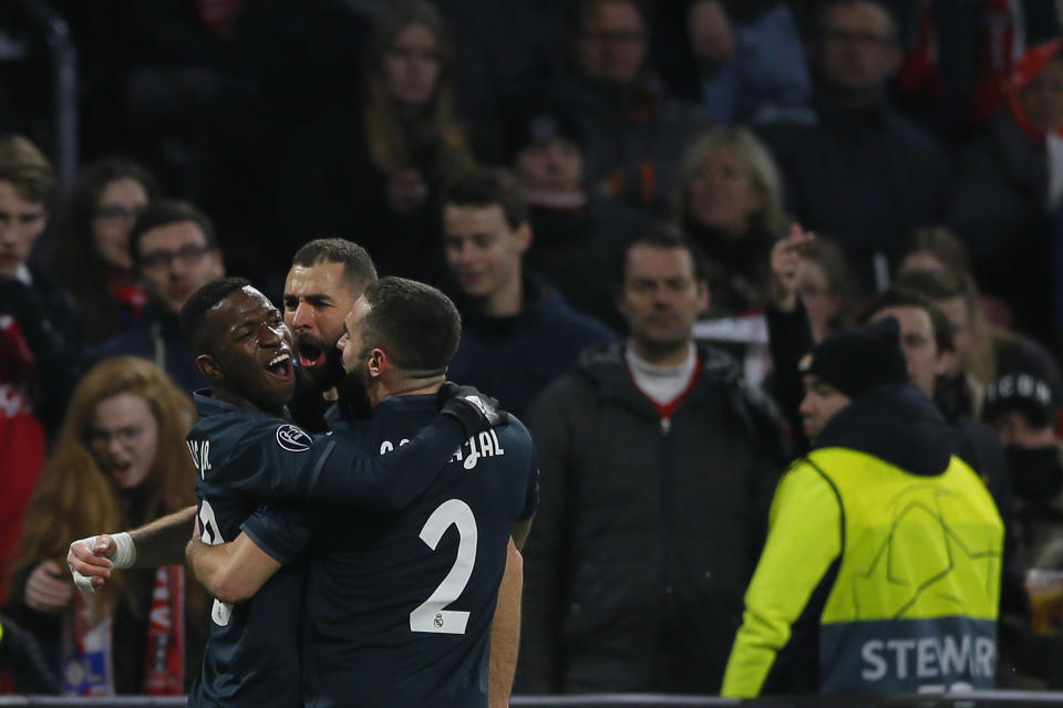 Real forward Karim Benzema, center, celebrates with his teammates after scoring his side's opening goal during the first leg, round of sixteen, Champions League soccer match between Ajax and Real Madrid at the Johan Cruyff ArenA in Amsterdam, Netherlands, Wednesday Feb. 13, 2019. (AP Photo/Peter Dejong)