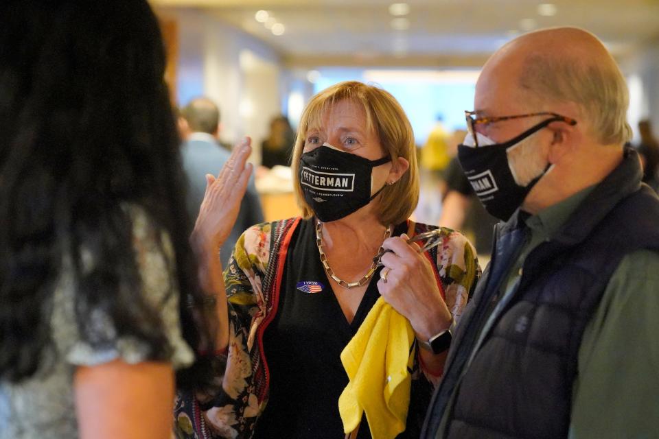 Denise Seiffer, middle, and her husband, John, talk with Gisele Barreto Fetterman, left, the wife of Pennsylvania Lt. Governor John Fetterman, who is running for the Democratic nomination for the U.S. Senate for Pennsylvania, at a hotel in Imperial, Pa., to watch election returns Tuesday, May 17, 2022