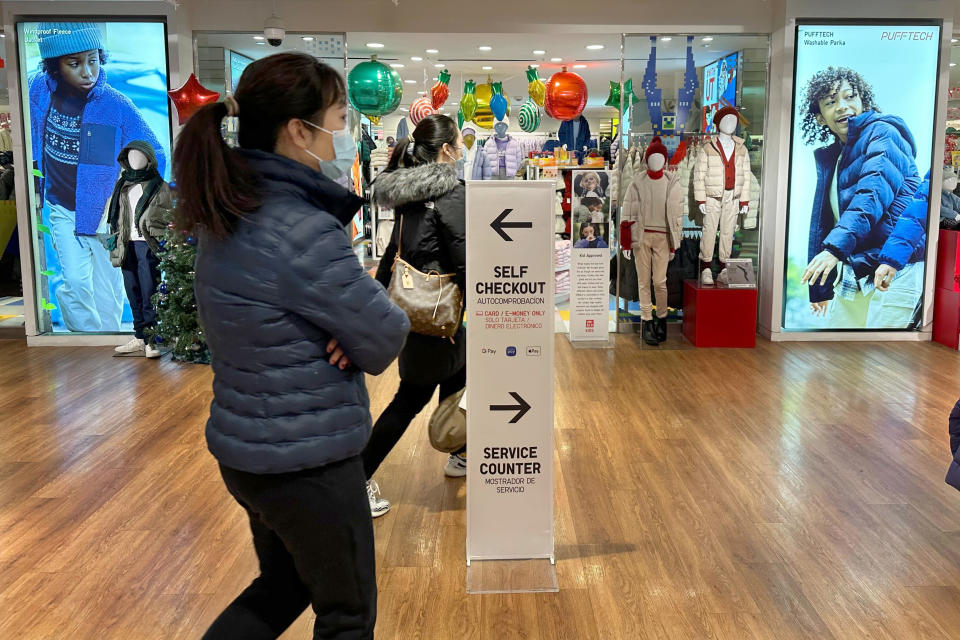 A sign pointing shoppers to self-checkout stations is shown at a store in New York on Wednesday, Dec. 6, 2023. Self-checkout faces a reckoning of sorts just as retailers are in the midst of their busiest time of the year. (AP Photo/Anne D'Innocenzio)