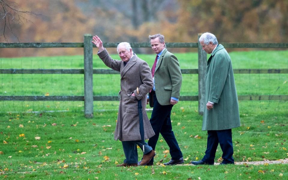 King Charles waves as he walks to church on the Royal Sandringham estate, in Norfolk, accompanied by friends - Geoff Robinson