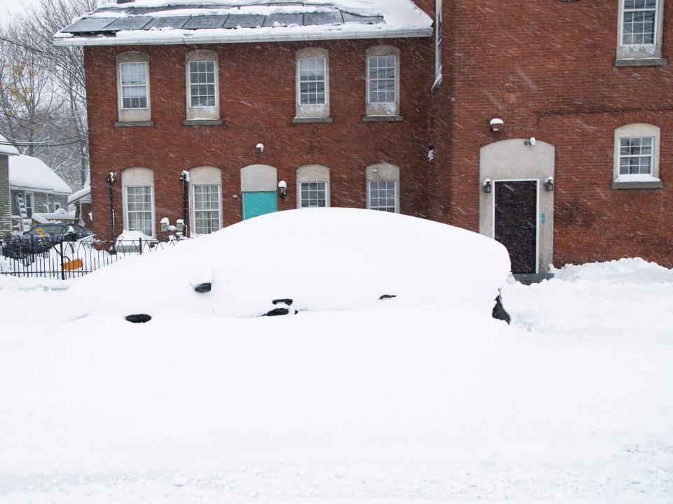 A car in South Buffalo peaks from under a mass of snow after a snowstorm in Buffalo, New York on Friday Nov. 18, 2022.