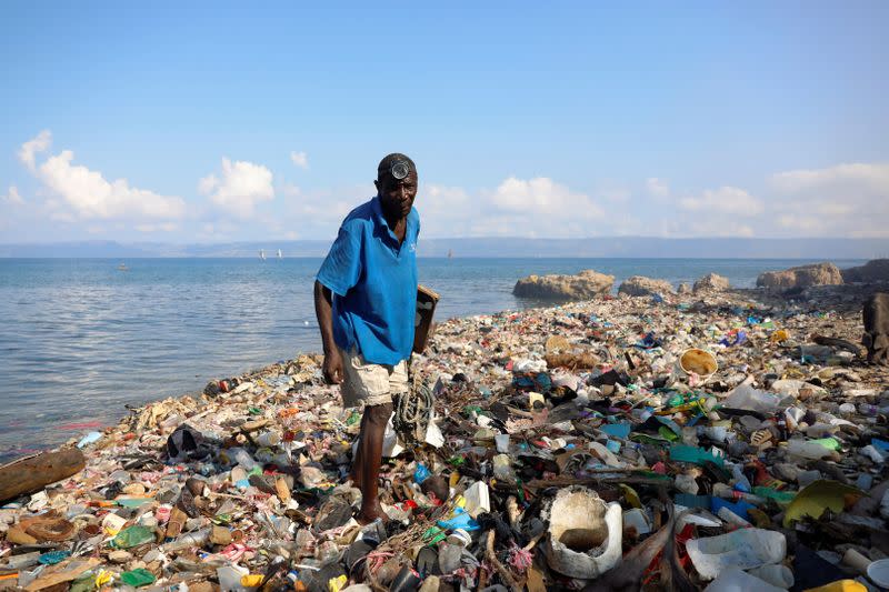 A fisherman returns to a trash-strewn shore in the impoverished Nan Palan area of Port-de-Paix