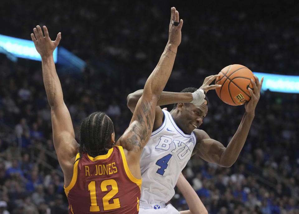 Iowa State forward Robert Jones (12) defends against BYU forward Atiki Ally Atiki (4) during the second half of an NCAA college basketball game Tuesday, Jan. 16, 2024, in Provo, Utah. (AP Photo/George Frey)