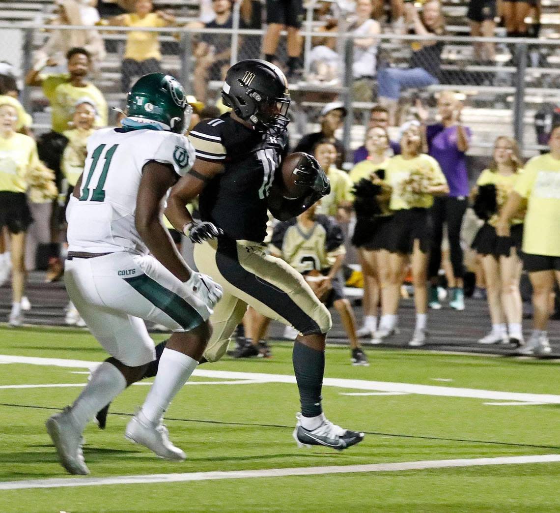 Fossil Ridge running back Landen Chambers (11) steps into the end zone ahead of Arlington’s Jourdyn Landrum in the second half of a high school football game at Keller ISD Stadium in Keller, Texas, Thursday, Sept. 08, 2022. Keller Fossil Ridge defeated Arlington High School 39-34. (Special to the Star-Telegram Bob Booth)