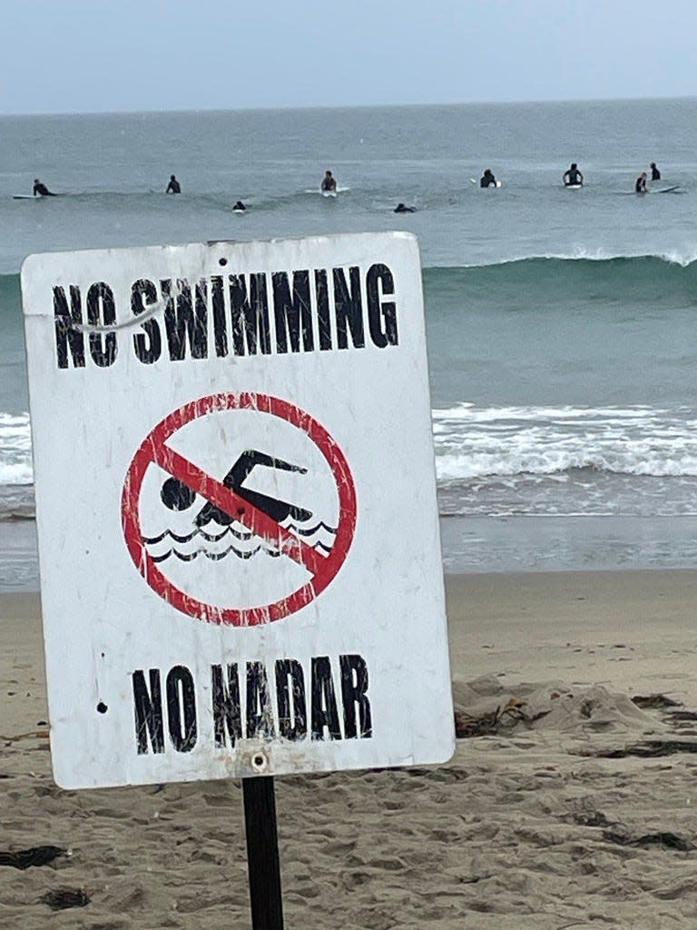 Surfers line up to catch the "glassy'' waves at Venice Beach while not technically breaking any rules.