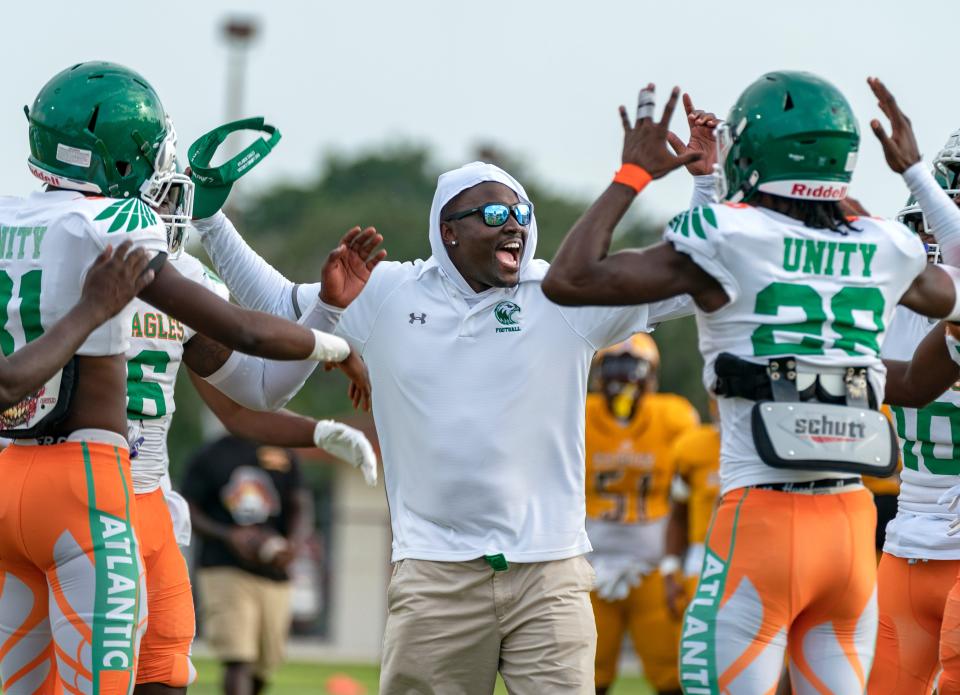 Atlantic head coach Jamael Stewart gets his players excited for their game against Glades Central in Belle Glade on Sept. 9, 2021.