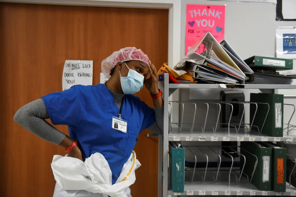 Theresa Ogunjimi, a registered nurse, rests for a moment inside a coronavirus disease (COVID-19) unit at United Memorial Medical Center, as the United States nears 300,000 COVID-19 deaths, in Houston, Texas, U.S., December 12, 2020. Picture taken December 12, 2020. REUTERS/Callaghan O&#39;Hare