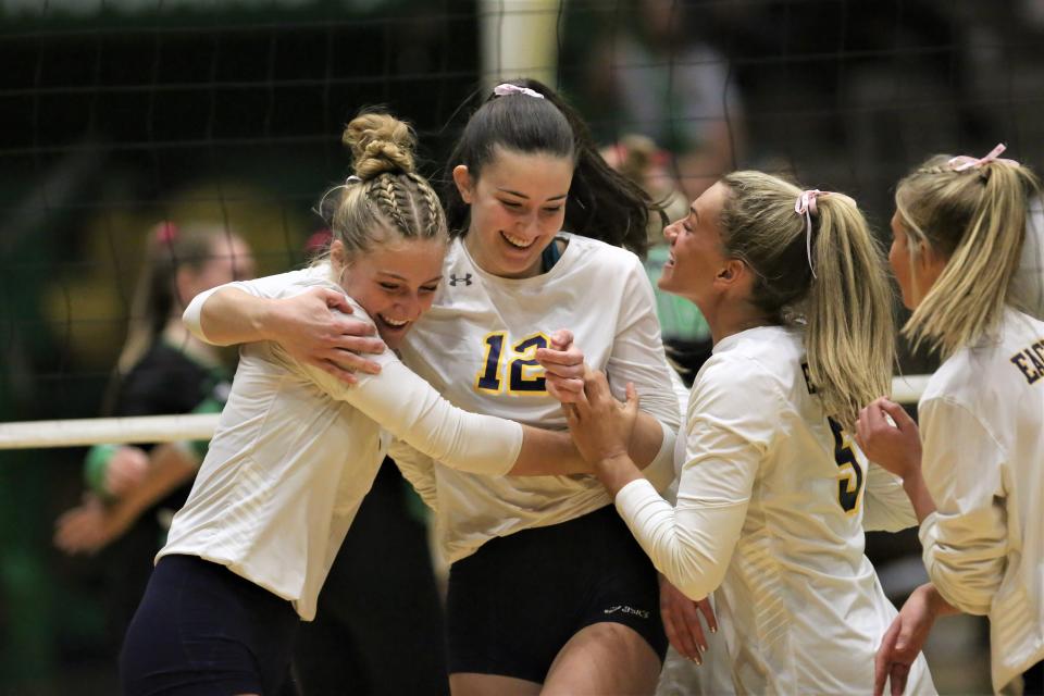 (From left to right): Delta volleyball's Olivia Morris, Emily Reno and Kendra Keesling celebrate a point in the team's sectional first round match against New Castle at New Castle High School on Thursday, Oct. 13, 2022.