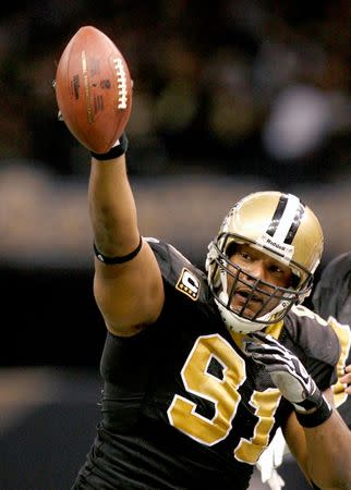 New Orleans Saints defensive end Will Smith celebrates his second quarter interception during play against the Arizona Cardinals in their NFL Divisional playoff football game in New Orleans, Louisiana, January 16, 2010. REUTERS/Sean Gardner