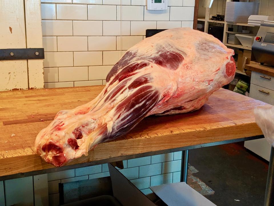 A leg of beef awaits being butchered at Western Daughters in Denver. (Photo: Lee Breslouer/For HuffPost)