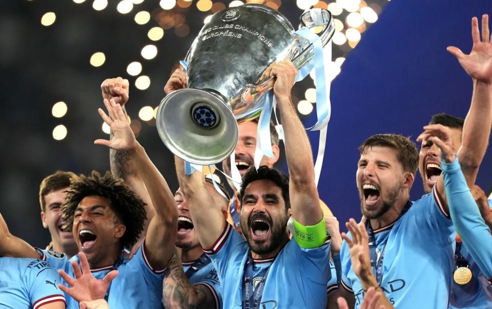 Manchester City's Ilkay Gundogan lifts the UEFA Champions League Trophy - PA