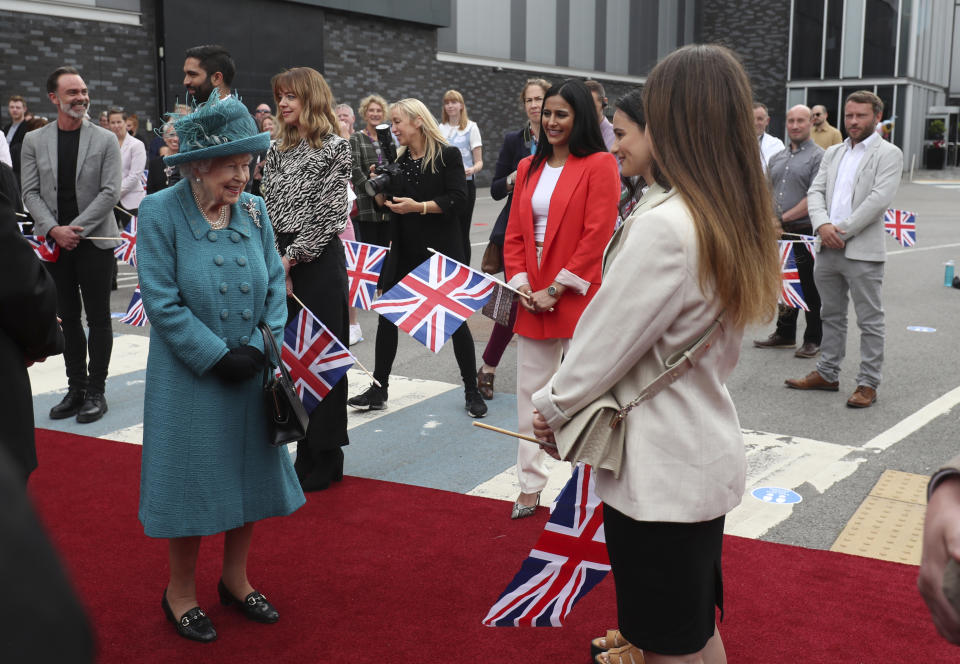 Britain's Queen Elizabeth II meets actors during a visit to the studio of the long running television series Coronation Street, in Manchester, England, Thursday July 8, 2021. (AP Photo/Scott Heppell)