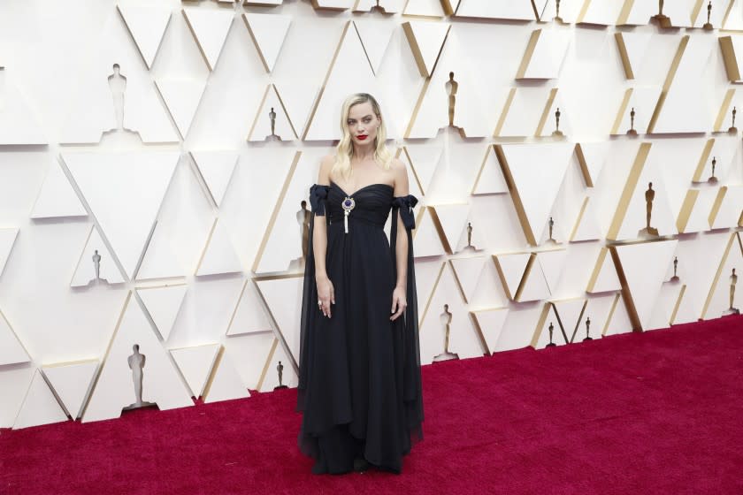 Margot Robbie was part of Sunday’s sustainability fashion message at the Oscars. She wore a navy-blue silk Chanel bustier dress from the spring-summer 1994 haute couture collection.(Jay L. Clendenin / Los Angeles Times)