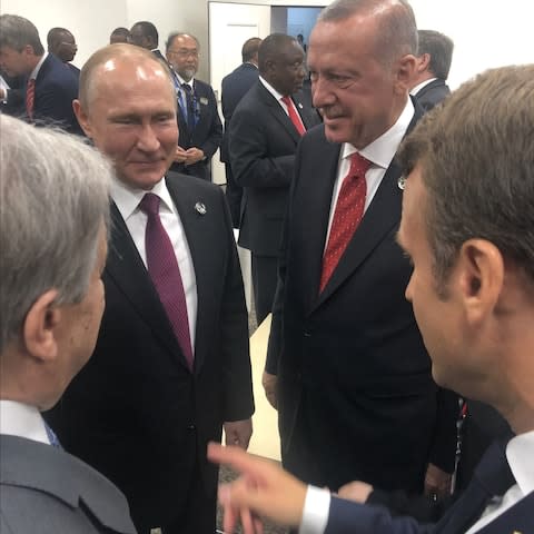 A photo distributed by President Recep Tayyip Erdogan shows the Turkish presiden with Mr Putin and Emmanuel Macron - Credit: Anadolu