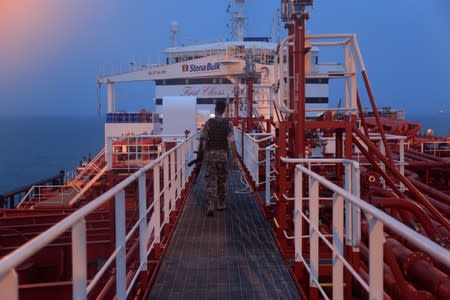 An Iranian Revolutionary Guard member walks onboard of Stena Impero, a British-flagged vessel owned by Stena Bulk, in Bandar Abbas port