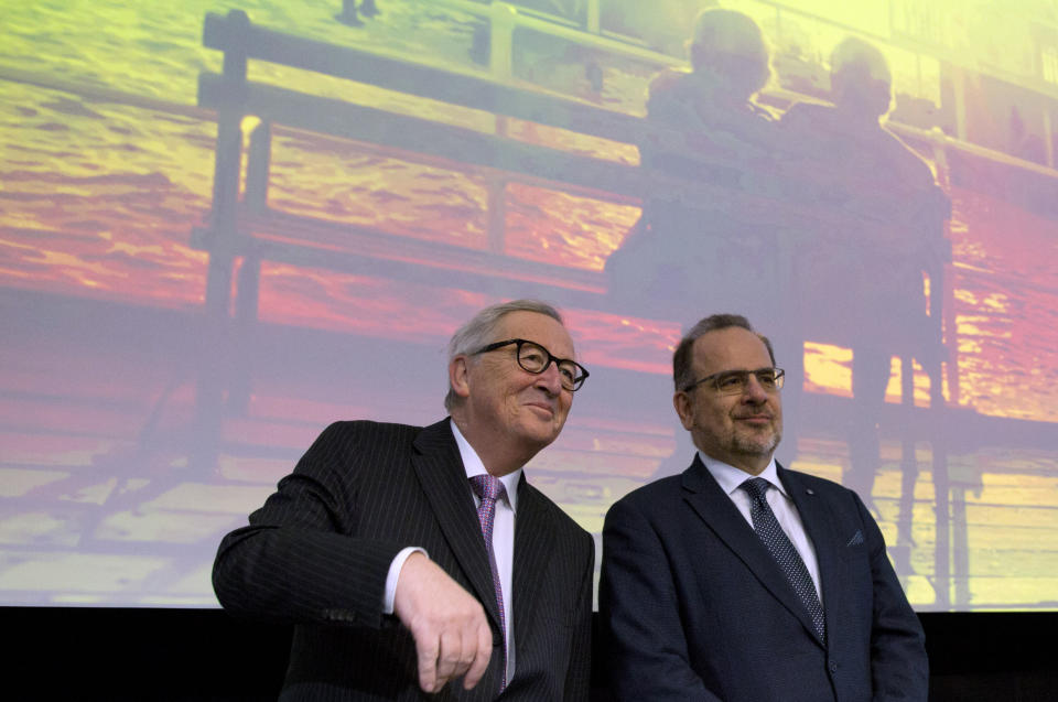 European Commission President Jean-Claude Juncker, left, attends an event at the EU Charlemagne building in Brussels, Thursday, Feb. 21 2019. EU Commission President Jean-Claude Juncker says that despite constructive talks with British Prime Minister Theresa May he remains downbeat on the prospect of avoiding a chaotic exit of Britain from the bloc next month. (AP Photo/Virginia Mayo)