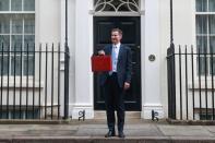 British Chancellor of the Exchequer Jeremy Hunt holds the budget box on Downing Street in London