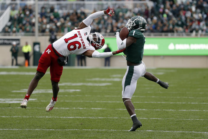Michigan State receiver Jayden Reed, right, catches a pass against Rutgers defensive back Max Melton (16) during the first half of an NCAA college football game, Saturday, Nov. 12, 2022, in East Lansing, Mich. (AP Photo/Al Goldis)