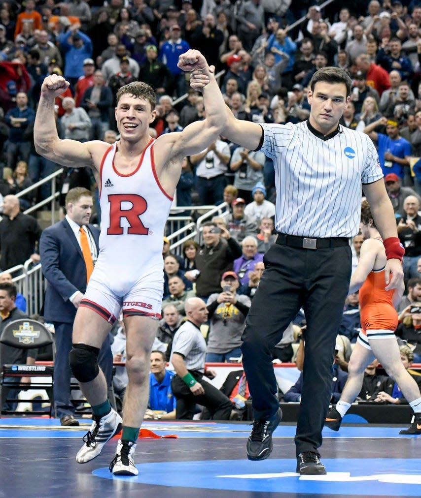 Nick Suriano, shown getting his hand raised after he won the 2019 NCAA Wrestling 133-pound championship and became Rutgers' first national wrestling champion, will wrestle for Michigan against Rutgers Sunday.