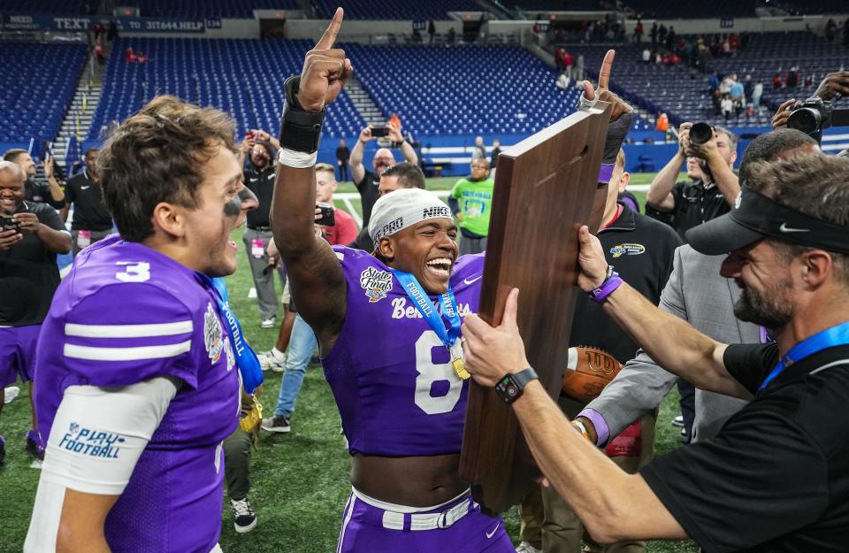 Ben Davis Giants linebacker Nylan Brown (8) yells in excitement with Ben Davis Giants head coach Russ Mann and Ben Davis Giants quarterback Thomas Gotkowski (3) on Saturday, Nov. 25, 2023, during the IHSAA Class 6A football state championship game at Lucas Oil Stadium in Indianapolis. The Ben Davis Giants defeated the Crown Point Bulldogs, 38-10.