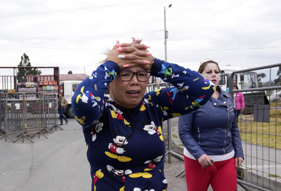 A woman cries as she waits for news of her loved one after a deadly prison riot in Latacunga, Ecuador, Tuesday, Oct. 4, 2022. A clash between inmates armed with guns and knives inside the prison has left at least 15 people dead and 20 injured. (AP Photo/Dolores Ochoa)