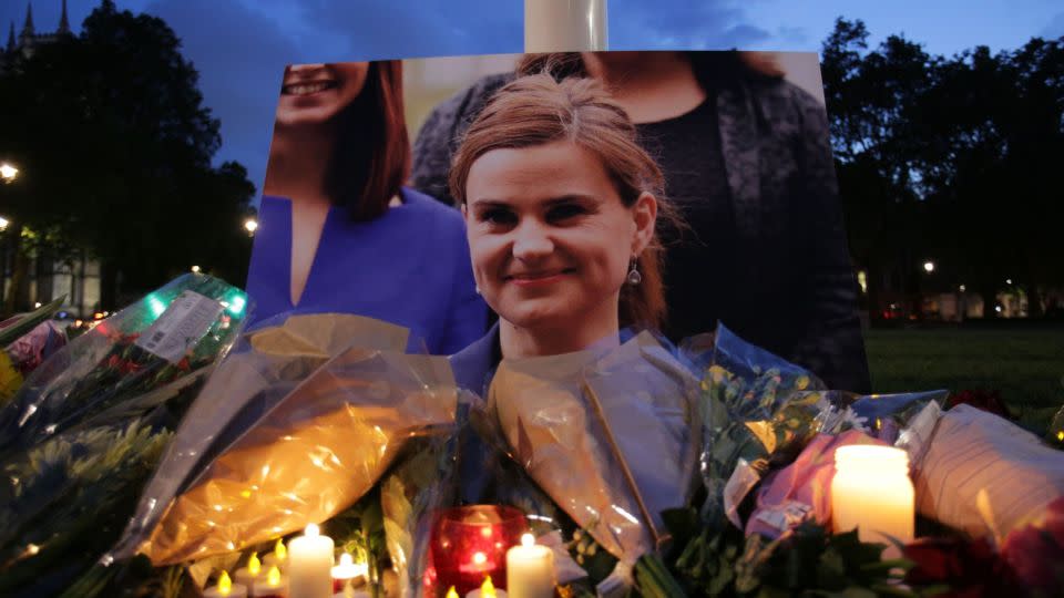 Floral tributes and candles are placed by a picture of slain British Labour parliamentarian Jo Cox at a vigil in Parliament square in London on June 16, 2016. - DANIEL LEAL-OLIVAS/AFP/AFP/Getty Images