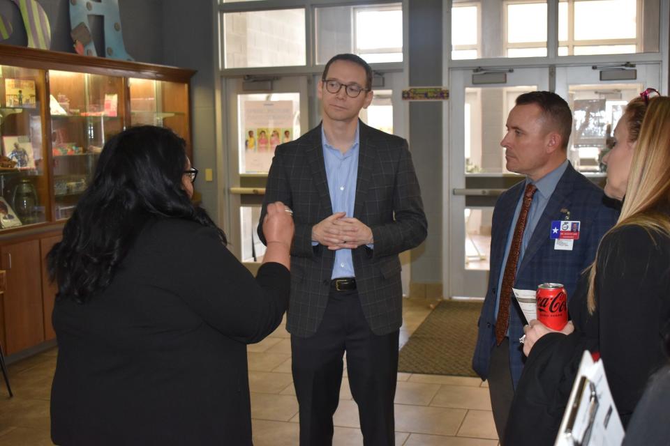 Texas Education Commissioner Mike Morath, second from left, and Dr. Donny Lee, Wichita Falls ISD superintendent, second from right, discuss curriculum with Southern Hills Principal Amanda Garcia, first from left, during Morath's visit to Wichita Falls on Tuesday, Feb. 20, 2024.