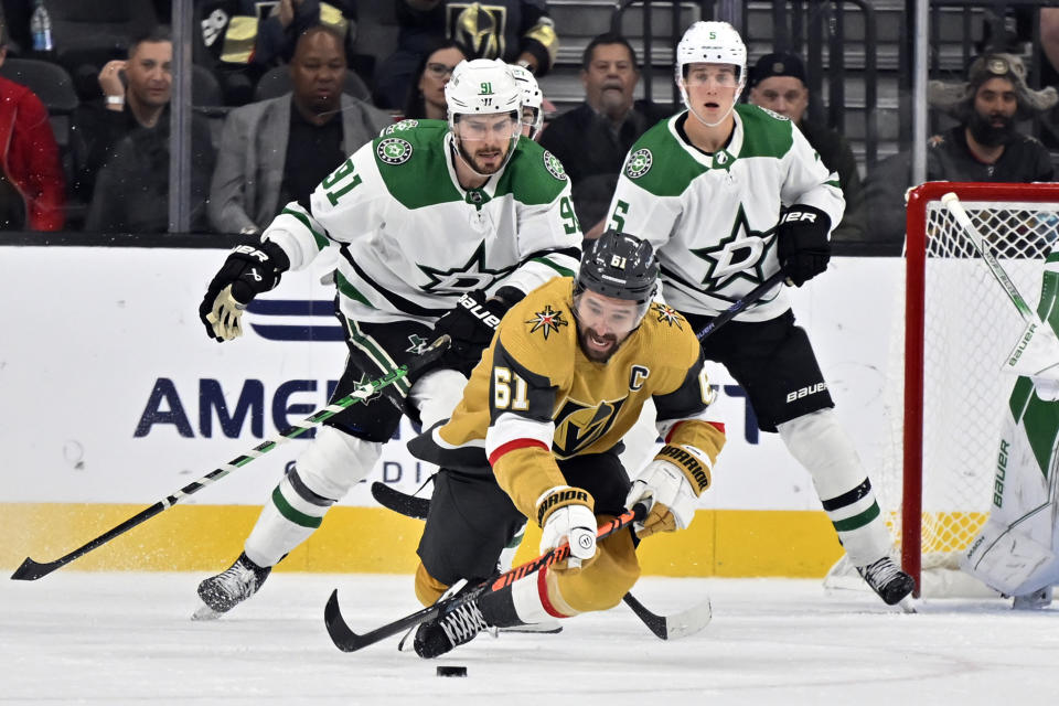 Vegas Golden Knights right wing Mark Stone (61) skates against Dallas Stars center Tyler Seguin (91) and defenseman Nils Lundkvist (5) during the first period of an NHL hockey game Tuesday, Oct. 17, 2023, in Las Vegas. (AP Photo/David Becker)