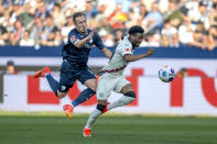 Bochum's Felix Passlack, left, fouls Leverkusen's Nathan Tella, right, and is shown the red card during the German Bundesliga soccer match between VfL Bochum and Bayer 04 Leverkusen in Bochum, Germany, Sunday, May 12, 2024. (David Inderlied/dpa via AP)