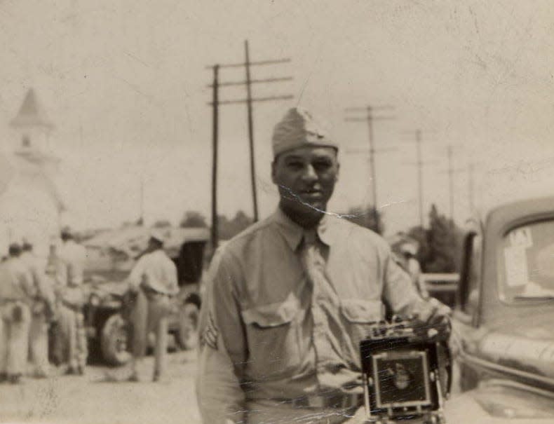 Canton photographer Taylor Matthews, at a time when he still was in the military, is pictured with his ever-present camera.