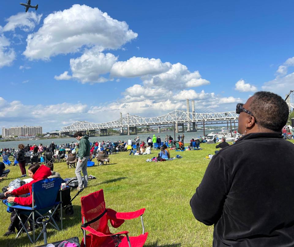 Lutitia Patterson watches a plane fly over the Ohio River from Waterfront Park during Thunder Over Louisville airshow on April 22, 2023.