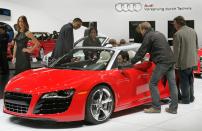 DETROIT, MI - JANUARY 11: Journalists look over an Audi R8 during the press preview of the North American International Auto Show at the Cobo Center on January 11, 2011 in Detroit, Michigan. The show is currently opened only for media previews and opens to the general public January 15-23. (Photo by Scott Olson/Getty Images)