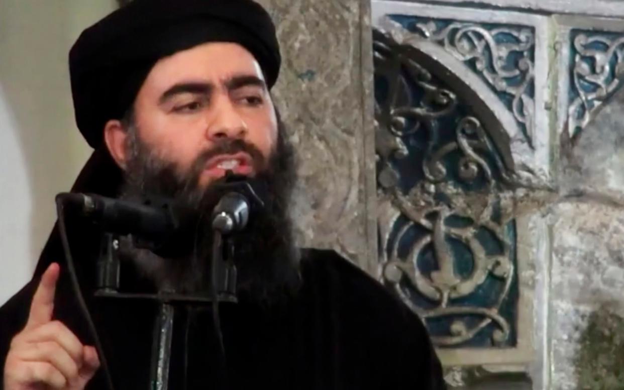 Abu Bakr al-Baghdadi, delivering a sermon at a mosque in Iraq during his first public appearance as Isil leader - Militant video