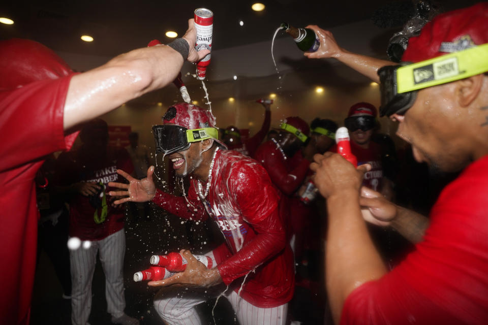 Philadelphia Phillies' Johan Rojas celebrates after winning a baseball game against the Pittsburgh Pirates to clinch a wild-card playoff spot, Tuesday, Sept. 26, 2023, in Philadelphia. (AP Photo/Matt Slocum)