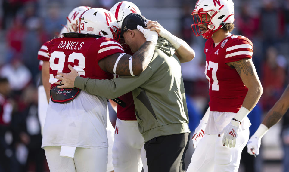 Nebraska head coach Scott Frost hugs players, including Nebraska defensive lineman Damion Daniels (93), during warmups before playing against Ohio State in an NCAA college football game Saturday, Nov. 6, 2021, at Memorial Stadium in Lincoln, Neb. (AP Photo/Rebecca S. Gratz)