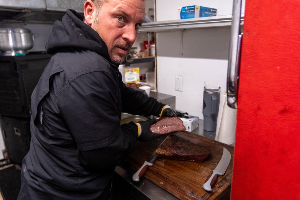 John Blanda shows off his smoked brisket at Nine Line BBQ on Hillside Road in Amarillo.